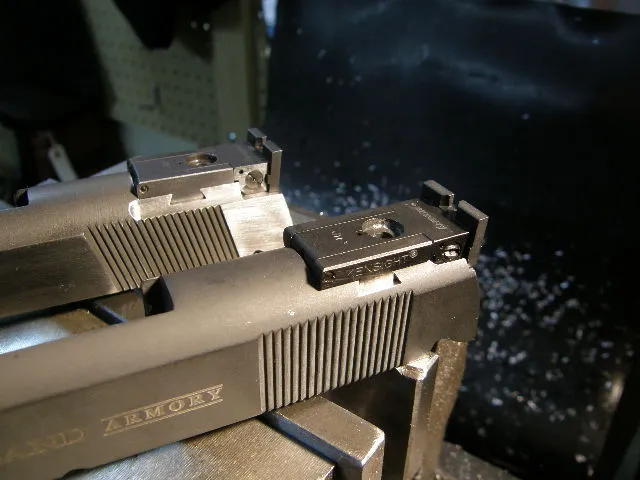 1911 pistol slides fixtured in a milling vise