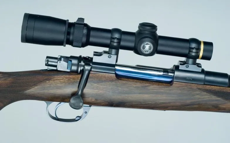 Close-up of the custom rifle action, bolt and scope