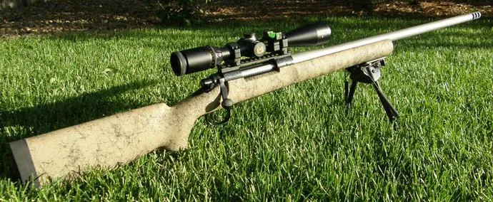 Rem 700 rifle with HS Precision stock on a bipod in the grass