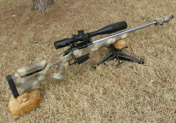 Tactical rifle with fluted barrel and scope on a bipod